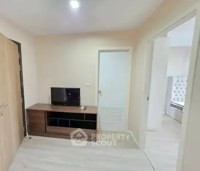 Modern apartment interior with TV unit and bedroom view