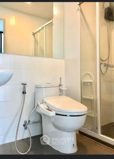 Modern bathroom with sleek fixtures and glass shower enclosure