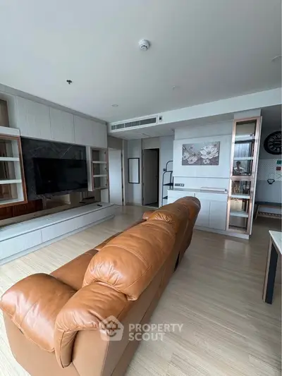 Modern living room with leather sofa and built-in entertainment center