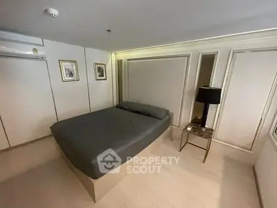 Modern bedroom with sleek design and elegant decor, featuring a comfortable bed and stylish lighting.