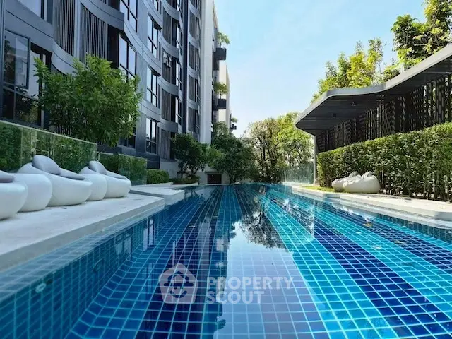 Luxurious condominium with stunning outdoor pool and modern architecture.