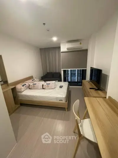 Modern bedroom with cozy bed, stylish furniture, and natural light, perfect for relaxation and comfort.
