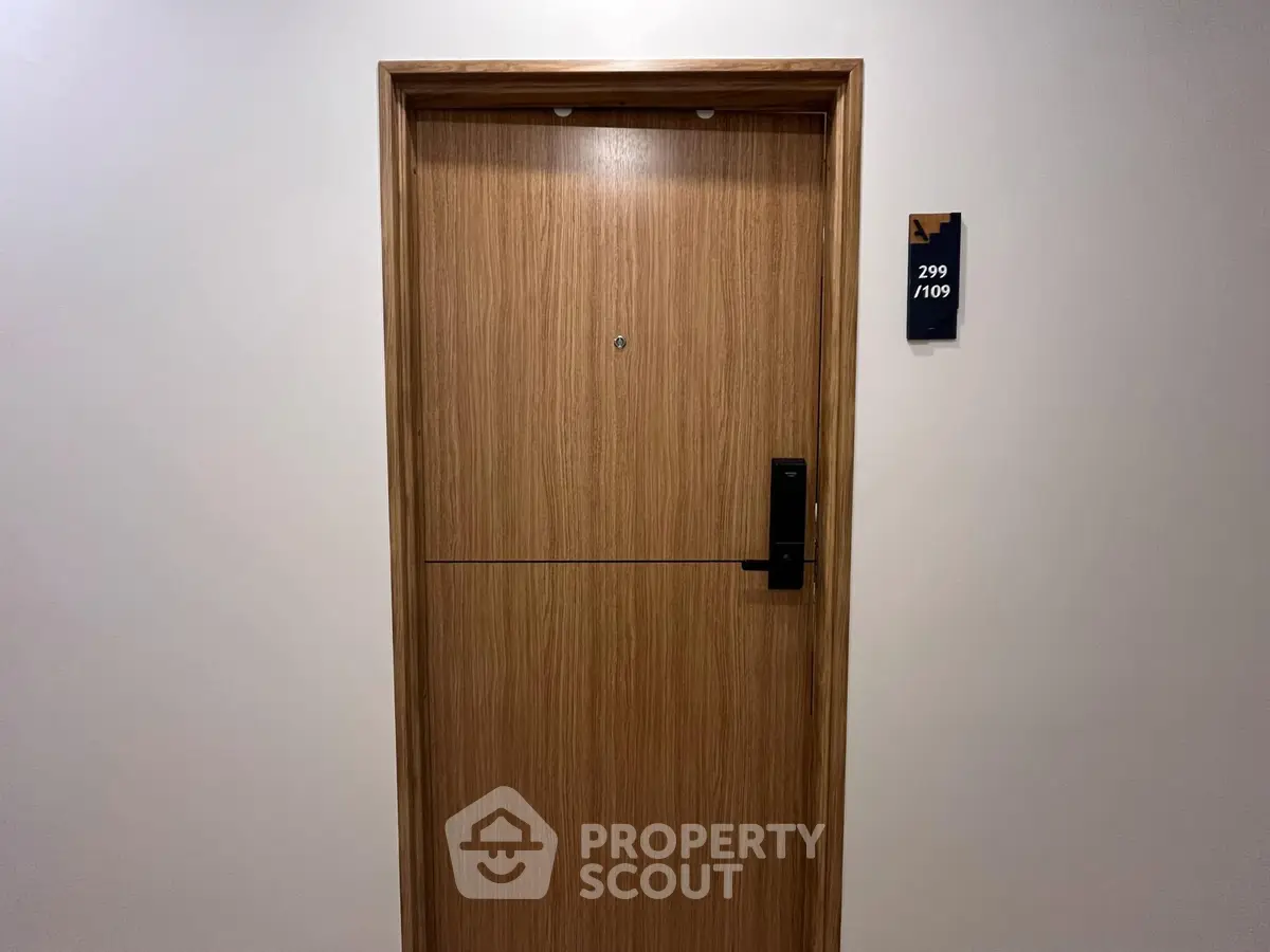 Modern apartment door with sleek design and room number plaque, ideal for urban living.