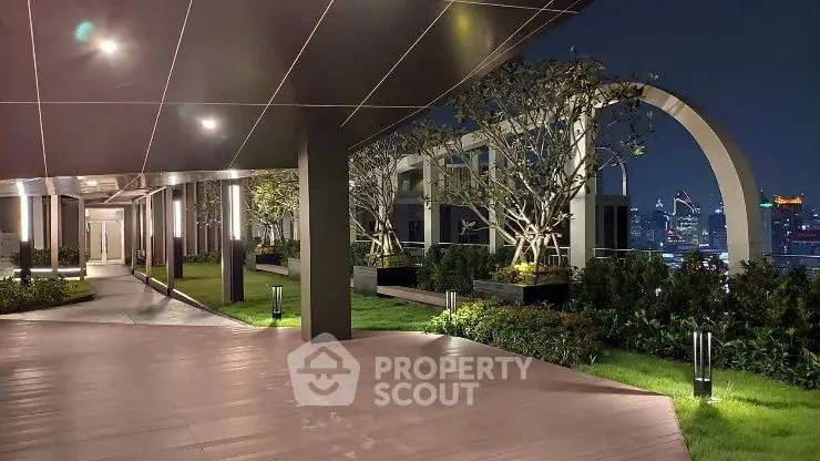 Luxurious rooftop garden with stunning city skyline views at night.