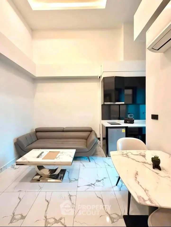 Modern living room with sleek furniture and open kitchen layout