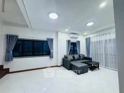 Spacious modern living room with elegant gray sofa and stylish curtains
