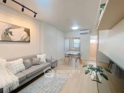 Modern living room with stylish decor and cozy seating area, perfect for relaxation and entertaining.