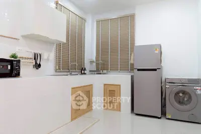 Modern kitchen with sleek appliances and ample storage space