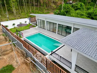 Luxurious modern villa with private pool and lush garden, perfect for serene living.