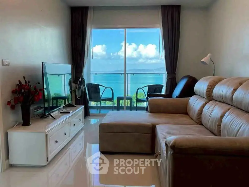 Luxurious living room with stunning ocean view and modern furnishings.