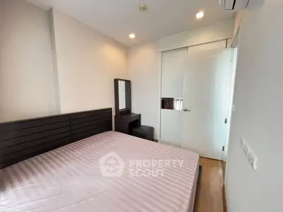 Modern bedroom with sleek furniture and ample natural light, perfect for a cozy retreat.