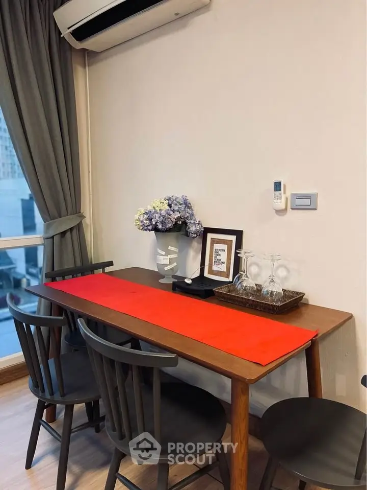 Chic dining area with modern table, chairs, and elegant decor in a cozy apartment setting.