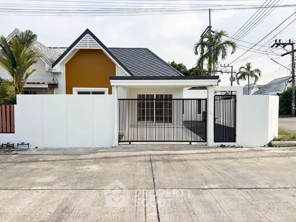 Charming single-story house with modern design and gated entrance in a serene neighborhood.