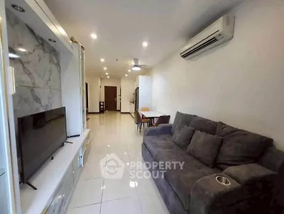 Spacious living room with modern decor and comfortable seating in a stylish apartment.