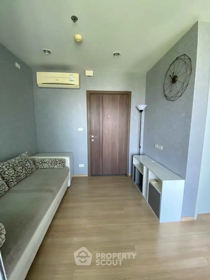 Modern living room with minimalist decor and air conditioning in a cozy apartment.