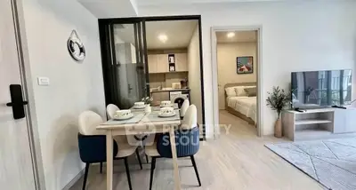 Modern open-plan living and dining area with stylish decor and cozy bedroom view.