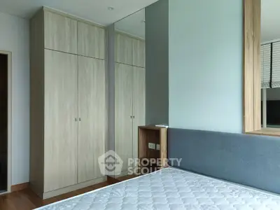 Spacious bedroom with modern wardrobe and comfortable bed in a stylish apartment