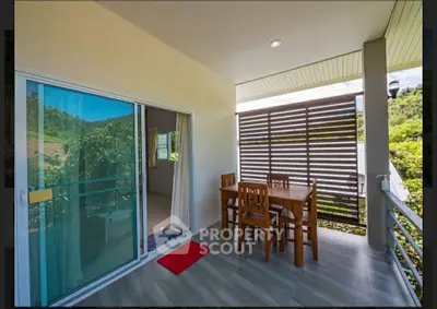 Charming balcony with scenic view and cozy dining set, perfect for relaxation and outdoor meals.