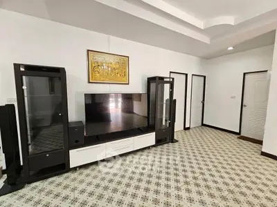 Spacious living room with modern TV stand and elegant patterned flooring