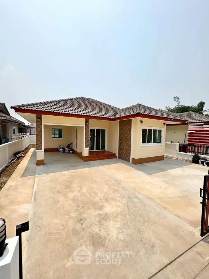 Charming single-story home with spacious driveway and modern exterior design.