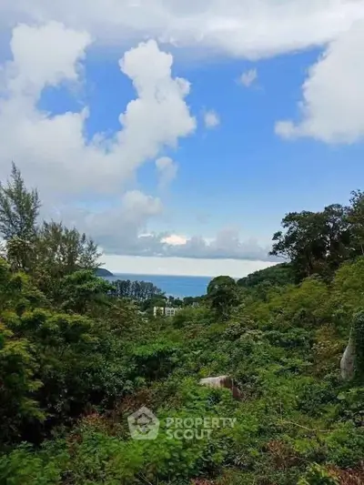 Scenic view of lush greenery with ocean backdrop, perfect for tranquil living.