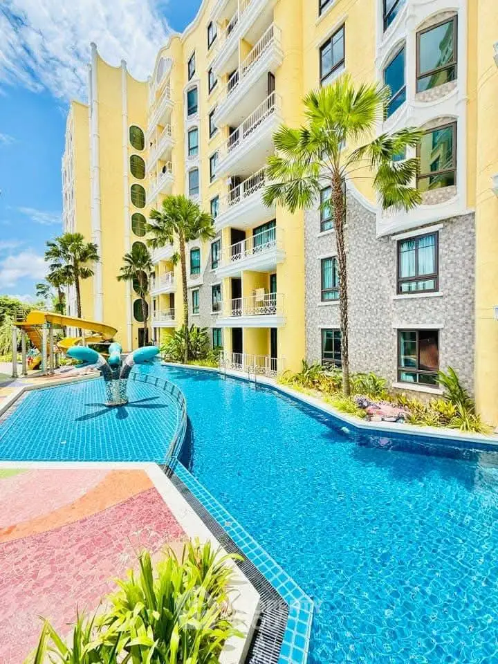 Stunning apartment building with a sparkling pool and lush palm trees, perfect for luxury living.
