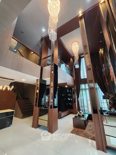 Luxurious modern living room with high ceilings and elegant chandeliers