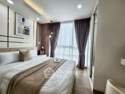 Luxurious bedroom with modern decor and large window for natural light