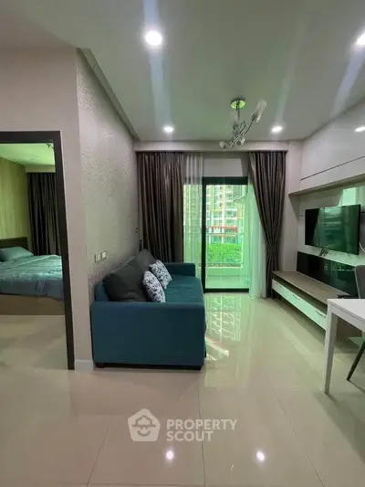 Modern living room with blue sofa and large window view