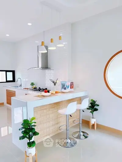 Modern kitchen with open layout and stylish breakfast bar seating