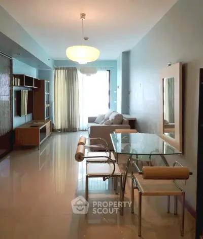 Modern living room with glass dining table and cozy seating area