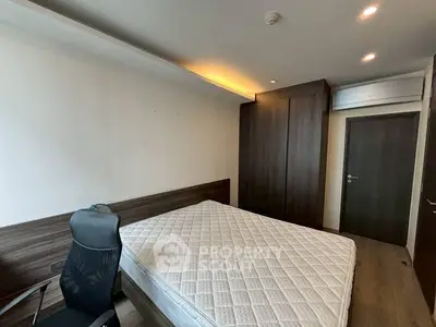 Modern bedroom with sleek wooden wardrobe and comfortable mattress in a stylish apartment.