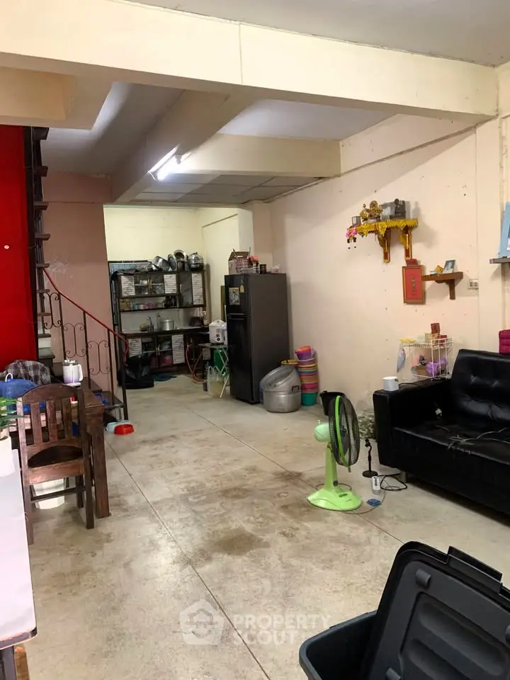 Spacious open-plan living area with modern furnishings and ample storage space.