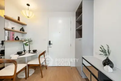 Modern dining area with stylish decor and wooden flooring in a cozy apartment.