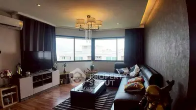 Stylish living room with modern decor and large windows offering natural light.