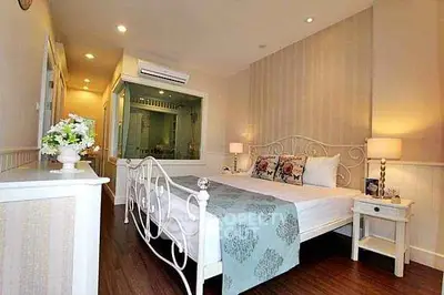 Charming bedroom with elegant decor and cozy ambiance, featuring a stylish bed and soft lighting.