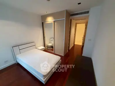 Modern bedroom with sleek design and wooden flooring