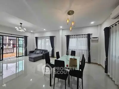 Spacious modern living room with elegant dining area and large windows.