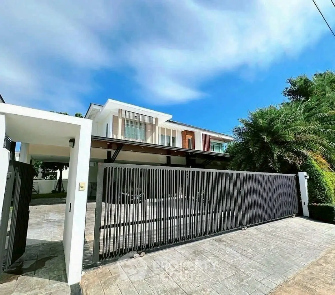 Modern luxury home with sleek design and spacious driveway, perfect for upscale living.
