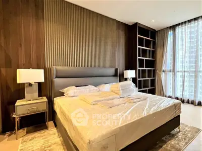 Luxurious bedroom with modern design and large windows offering city views.