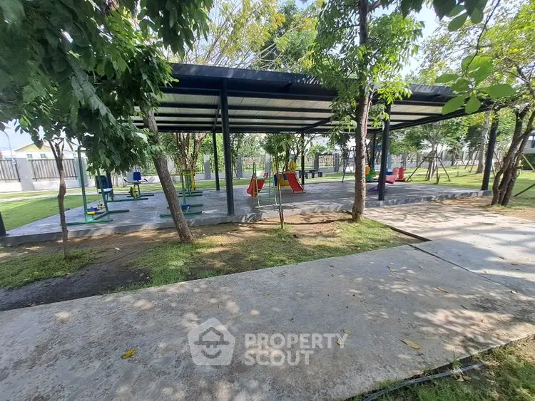 Spacious outdoor playground with modern equipment and lush greenery