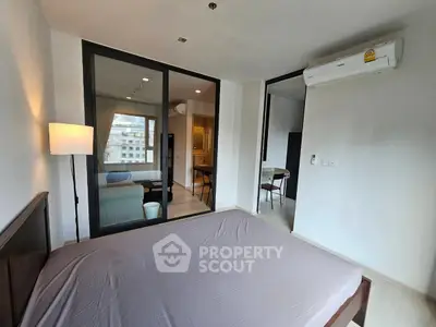 Modern bedroom with glass partition and air conditioning in urban apartment