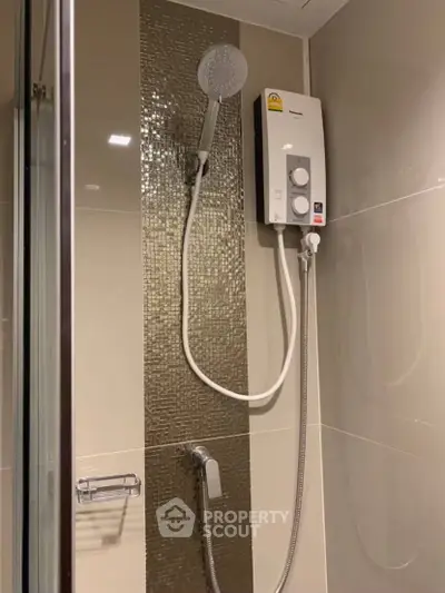 Modern bathroom with sleek shower and water heater in stylish apartment.