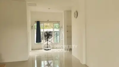 Spacious minimalist living room with large window and natural light