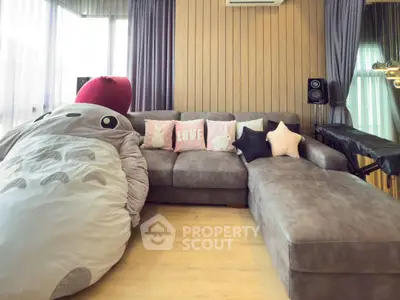 Spacious living room with cozy sectional sofa and plush decor, perfect for relaxation and entertainment.