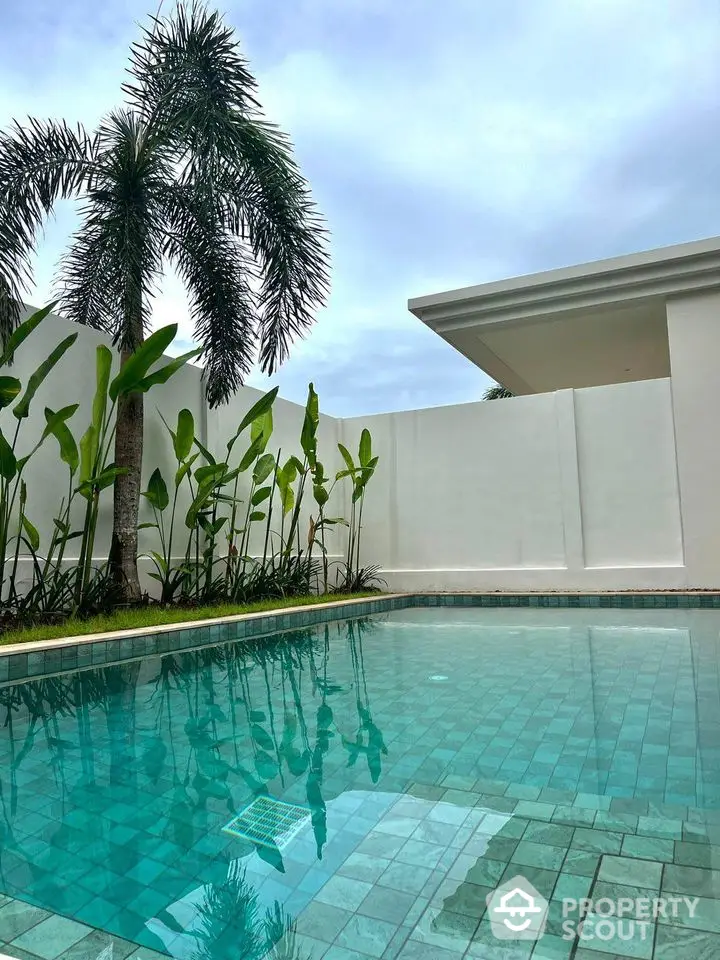 Luxurious private pool with tropical landscaping and modern architecture