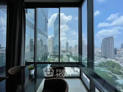 Stunning city view from modern high-rise apartment with floor-to-ceiling windows.