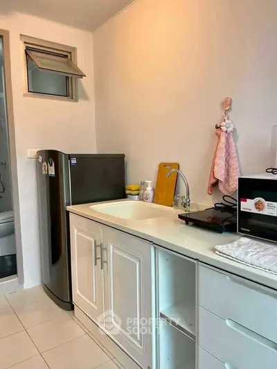 Compact kitchen with modern appliances and sleek cabinetry