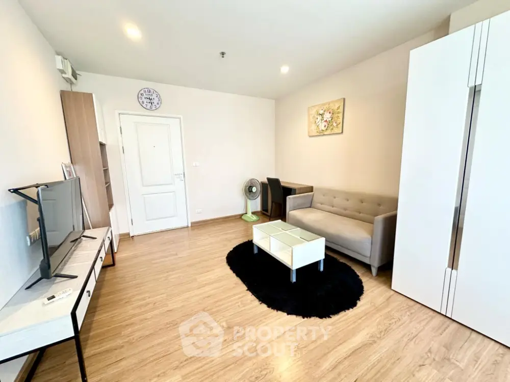 Modern living room with stylish furniture and wooden flooring in a cozy apartment.
