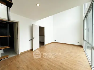 Spacious modern living room with high ceilings and large windows